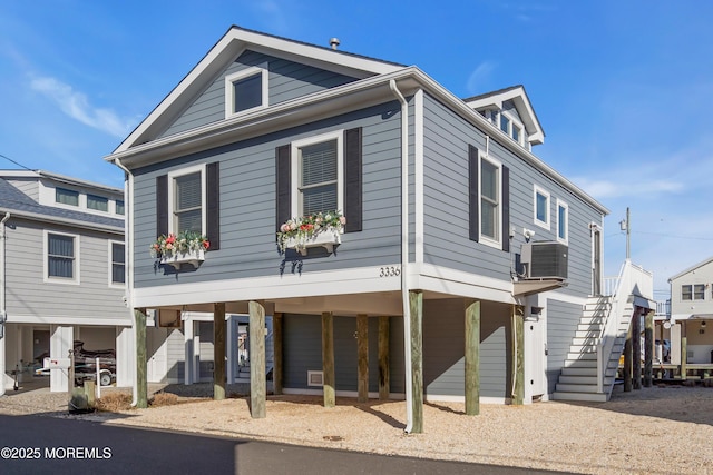 beach home featuring stairway, central air condition unit, and a carport