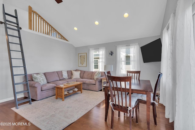 living room with recessed lighting, high vaulted ceiling, and wood finished floors