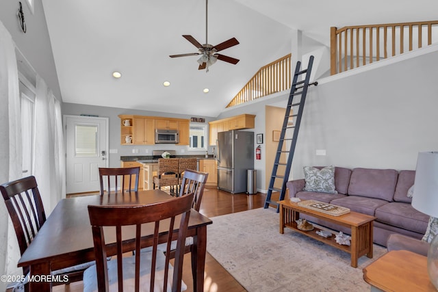 dining area featuring dark wood-type flooring, high vaulted ceiling, recessed lighting, and ceiling fan