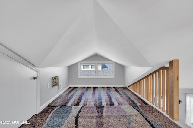 bonus room with visible vents, baseboards, carpet, and vaulted ceiling