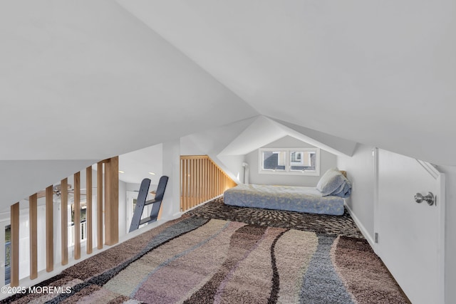 carpeted bedroom featuring vaulted ceiling