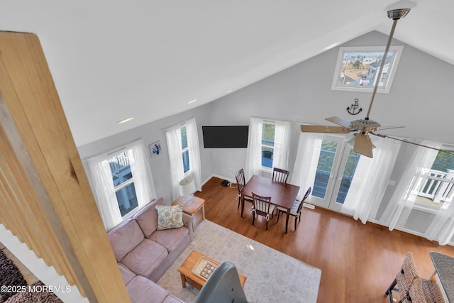 living area featuring recessed lighting, baseboards, wood finished floors, and vaulted ceiling