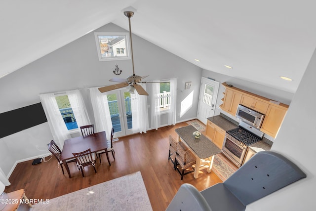 living area with wood finished floors, baseboards, french doors, and high vaulted ceiling