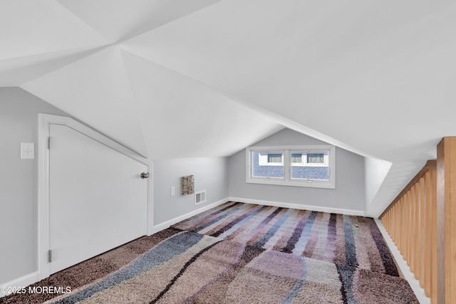 bonus room featuring visible vents, carpet floors, baseboards, and vaulted ceiling