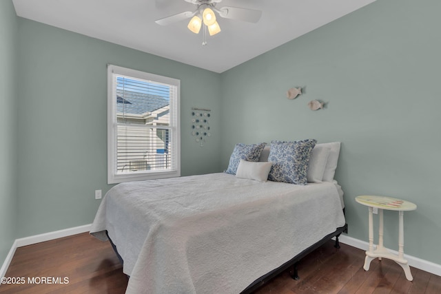 bedroom with a ceiling fan, baseboards, and wood finished floors