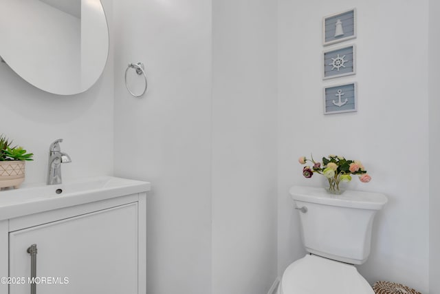 bathroom featuring toilet and vanity