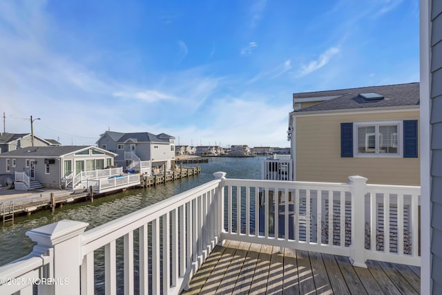 balcony with a residential view and a water view