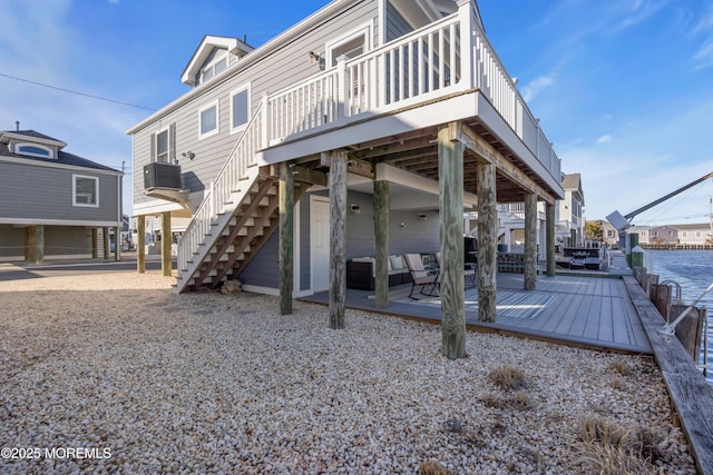 back of property featuring a patio area, stairs, and a deck