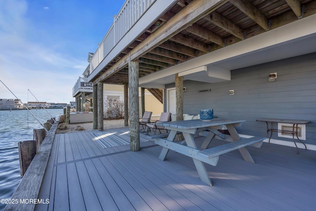 wooden deck featuring a water view