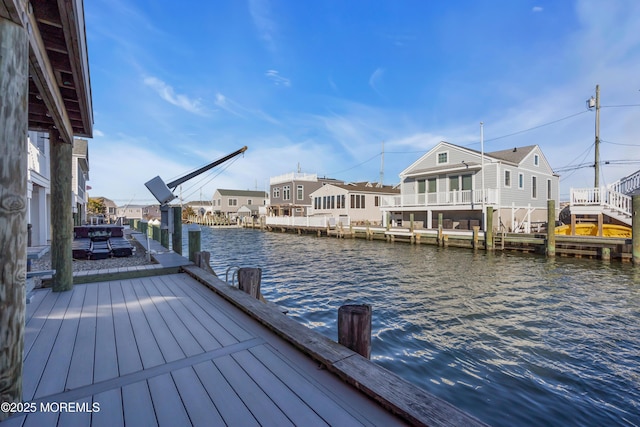 dock area featuring a residential view and a water view