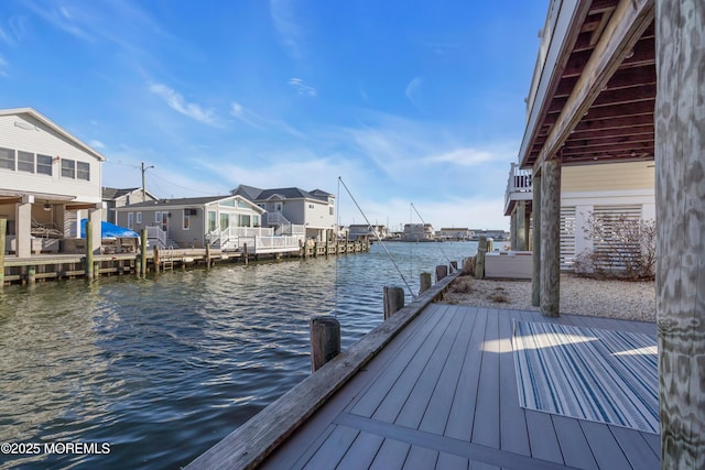 view of dock featuring a residential view and a water view