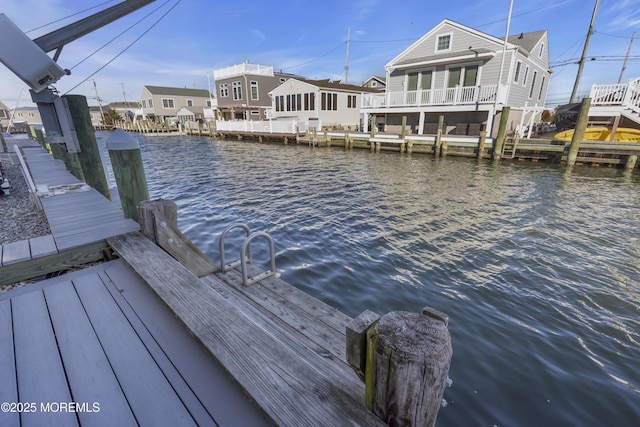 dock area featuring a residential view and a water view