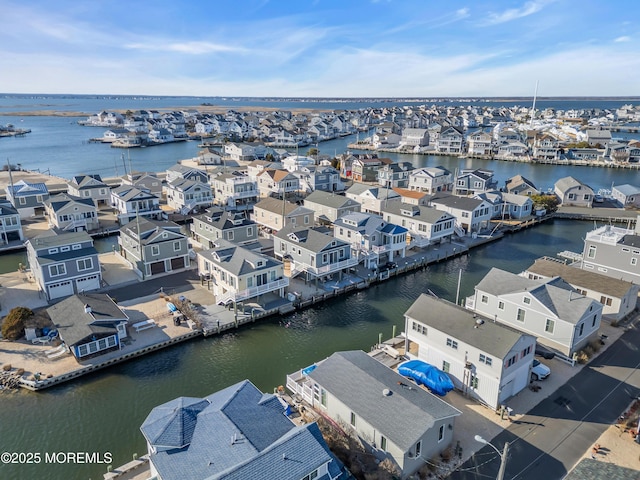 drone / aerial view featuring a residential view and a water view