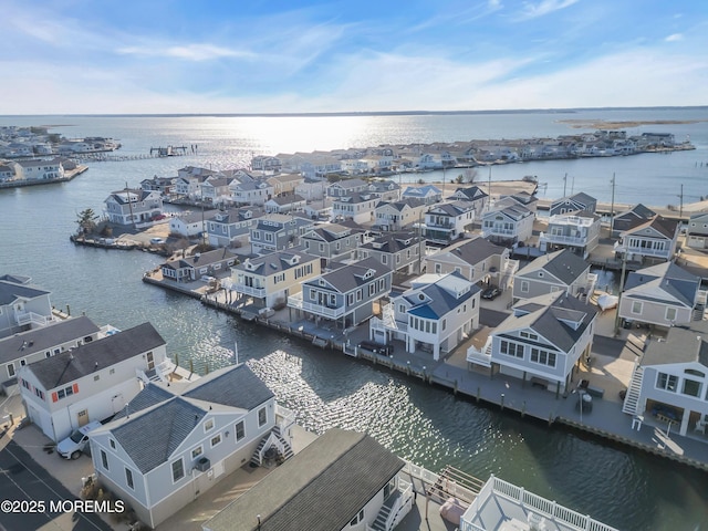 birds eye view of property featuring a water view and a residential view