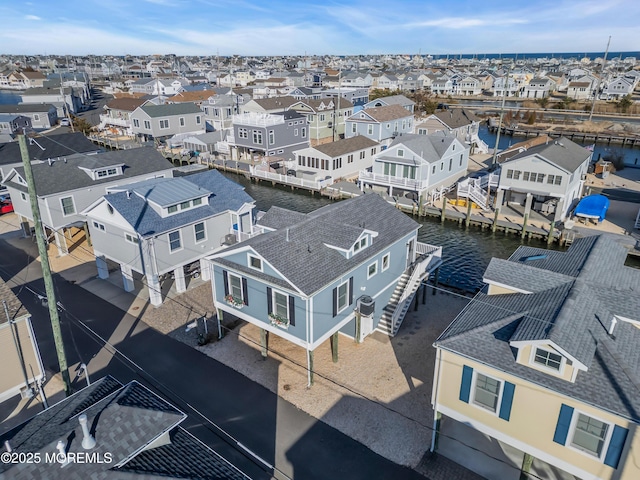 bird's eye view with a residential view and a water view