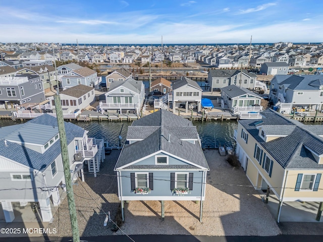 bird's eye view with a residential view and a water view