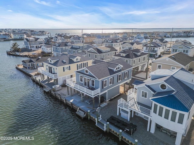 bird's eye view featuring a residential view and a water view