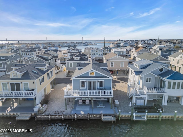 drone / aerial view featuring a residential view and a water view