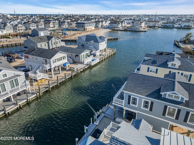 bird's eye view with a residential view and a water view