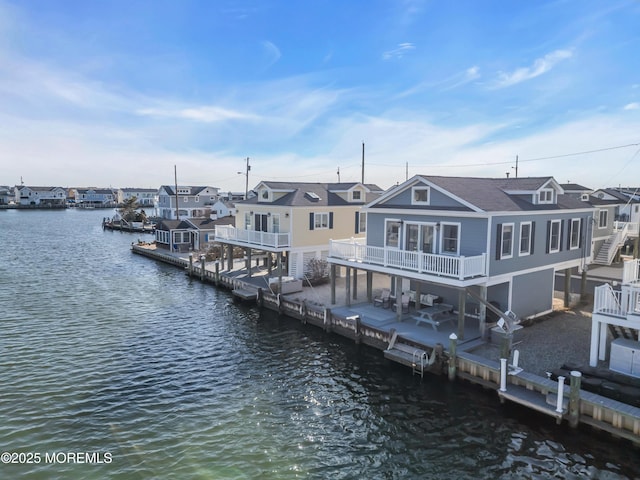 dock area featuring a water view and a residential view