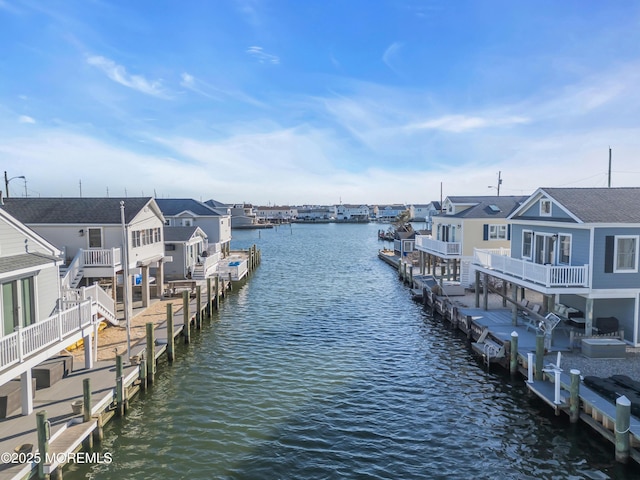 view of dock with a water view and a residential view