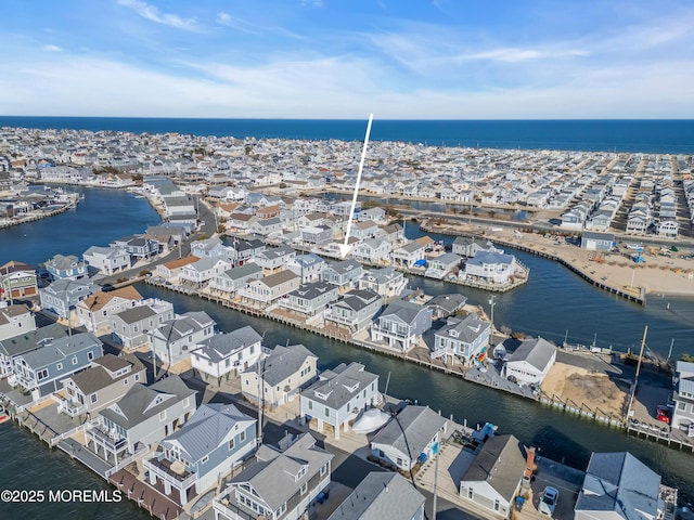 birds eye view of property with a residential view and a water view