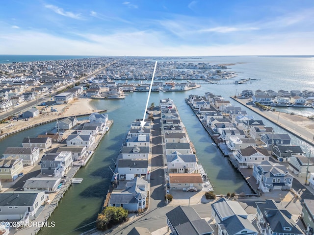 drone / aerial view featuring a water view and a residential view