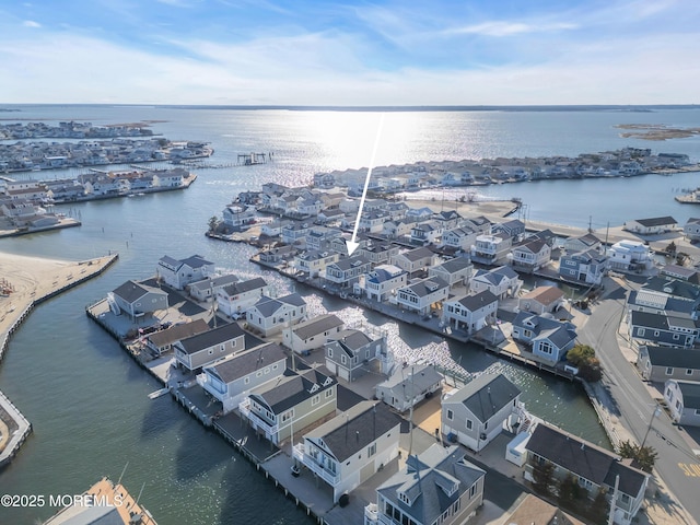 birds eye view of property with a water view and a residential view