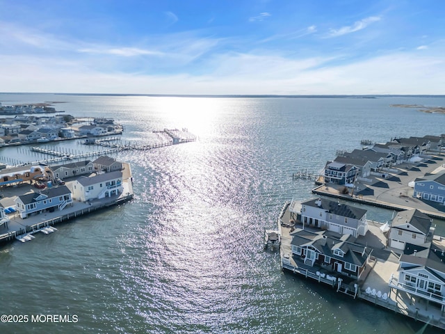 drone / aerial view with a residential view and a water view