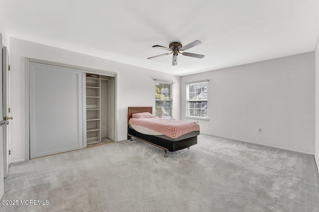 unfurnished bedroom featuring carpet, a closet, and ceiling fan