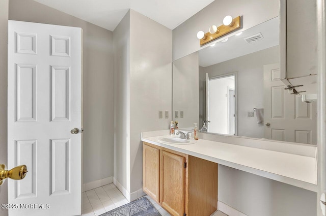 bathroom featuring visible vents, baseboards, vanity, and tile patterned flooring