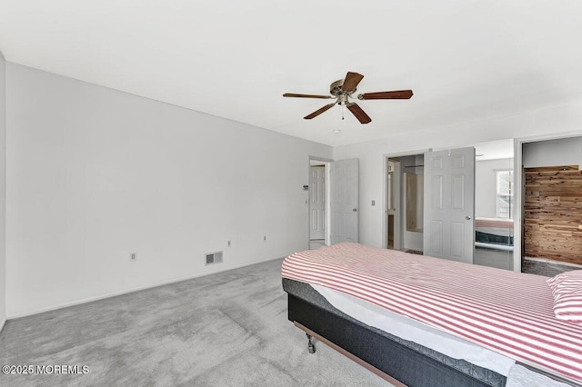 carpeted bedroom featuring visible vents and ceiling fan