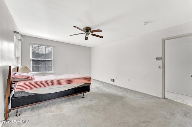 carpeted bedroom featuring visible vents and ceiling fan