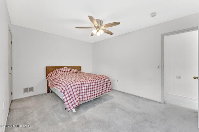 carpeted bedroom with visible vents and ceiling fan