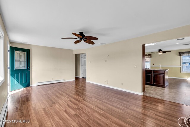 3172 Peddie St, Toms River, NJ 08753 - unfurnished living room featuring a baseboard radiator, wood finished floors, and ceiling fan