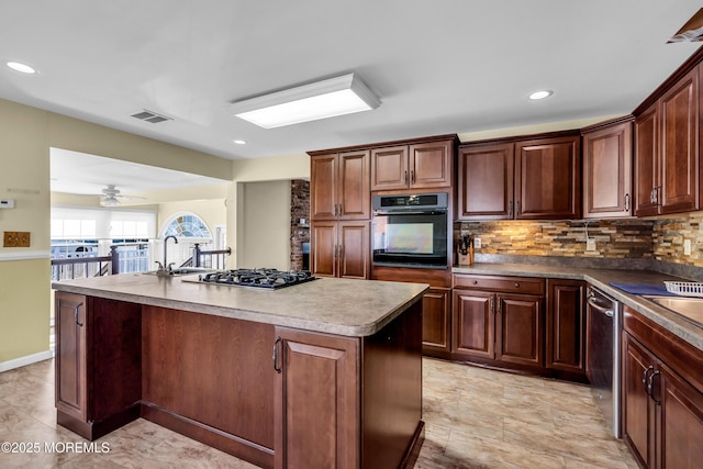3172 Peddie St, Toms River, NJ 08753 - kitchen with a kitchen island with sink, visible vents, decorative backsplash, and appliances with stainless steel finishes