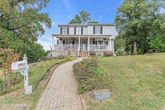 view of front of property with a porch and a front lawn