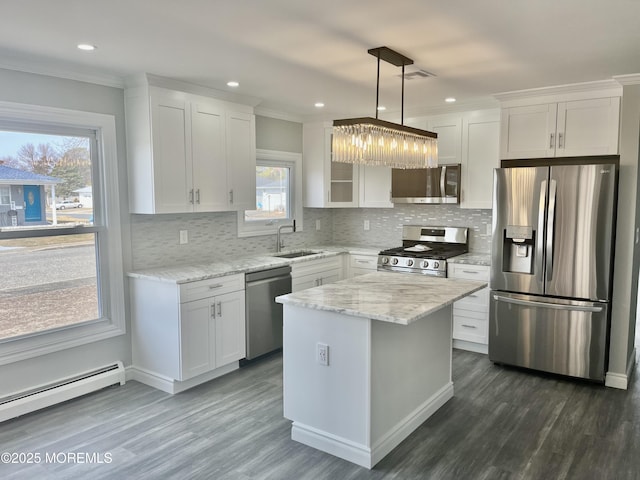 kitchen featuring ornamental molding, a sink, stainless steel appliances, white cabinetry, and baseboard heating