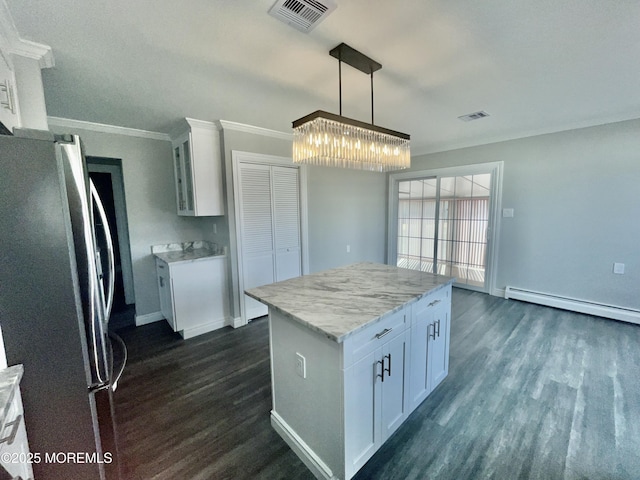 kitchen with a baseboard heating unit, dark wood-style flooring, visible vents, and freestanding refrigerator