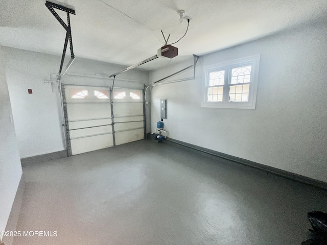 garage with electric panel, a garage door opener, and baseboards