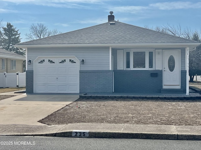 view of front of house featuring driveway, fence, roof with shingles, a garage, and brick siding