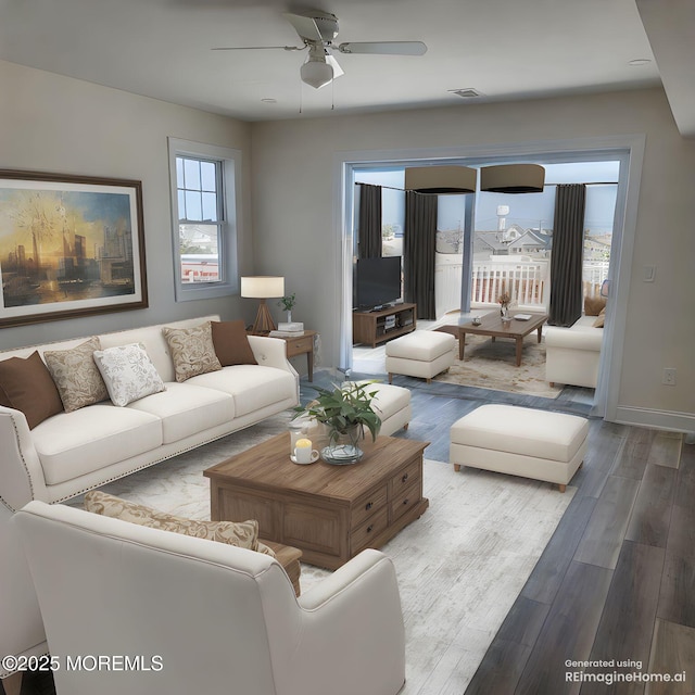 living room with visible vents, a ceiling fan, baseboards, and wood finished floors