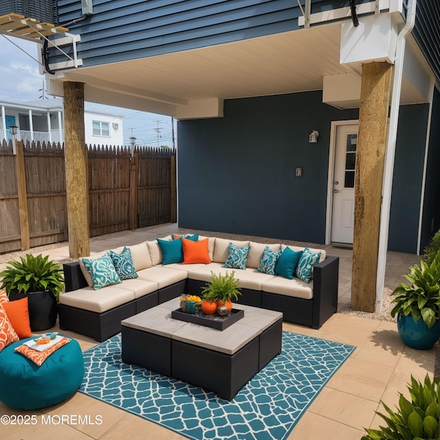 view of patio with an outdoor living space and fence