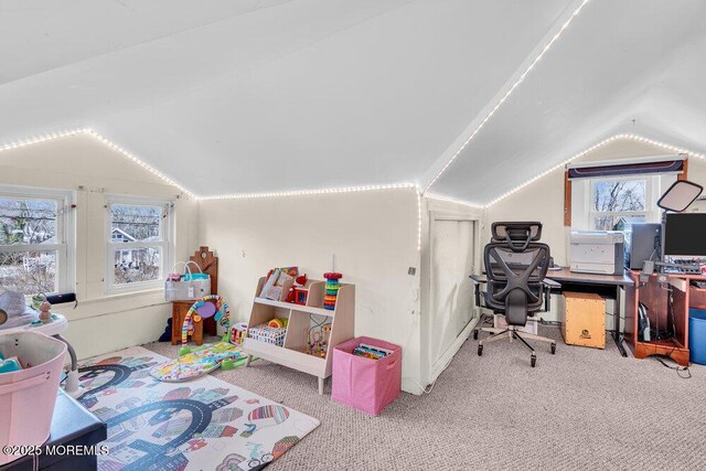 recreation room featuring a wealth of natural light, lofted ceiling, and carpet floors