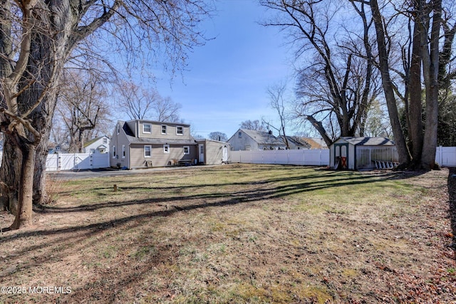 view of yard with an outbuilding and a fenced backyard