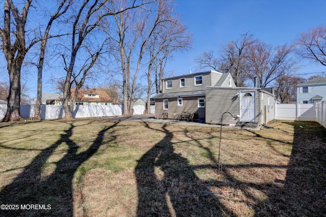 view of yard with entry steps and a fenced backyard