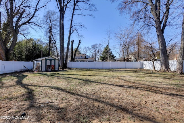 view of yard featuring a fenced backyard, an outdoor structure, and a shed