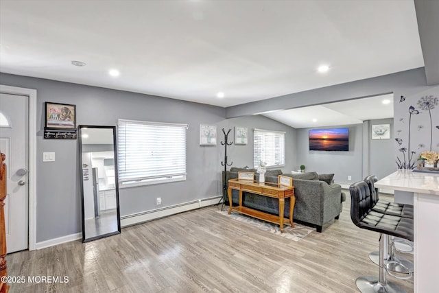 living room featuring baseboards, recessed lighting, vaulted ceiling, light wood-type flooring, and baseboard heating