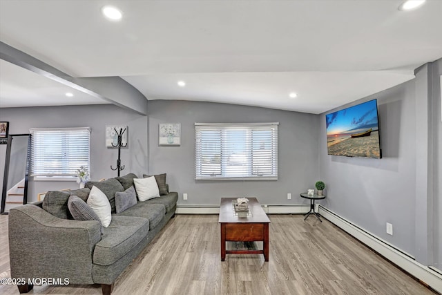 living area featuring recessed lighting, wood finished floors, a baseboard radiator, and a healthy amount of sunlight