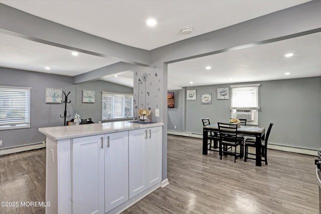 kitchen with plenty of natural light, baseboard heating, and light countertops